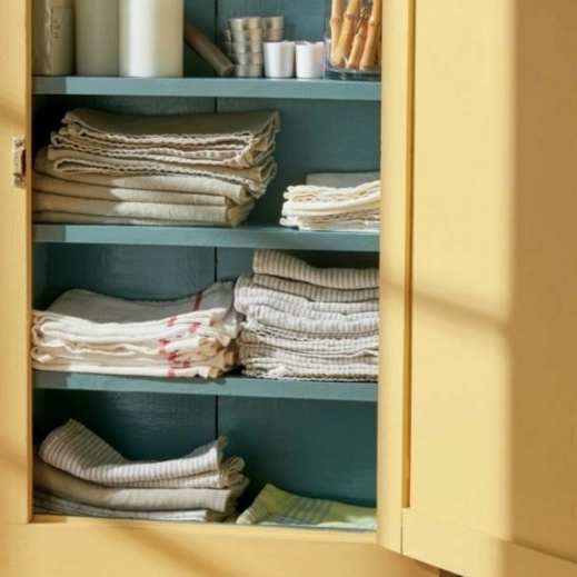 Blue and Yellow Hutch colored cabinet holding towels